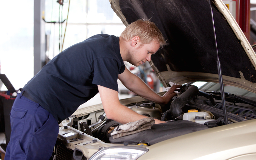 Mechanic fixing old car engine